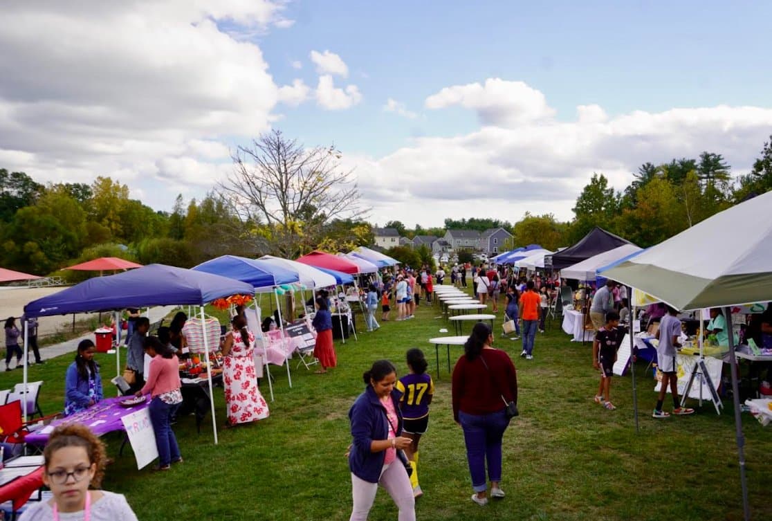 Crowd of families gathered at the BASK Fair by the lake